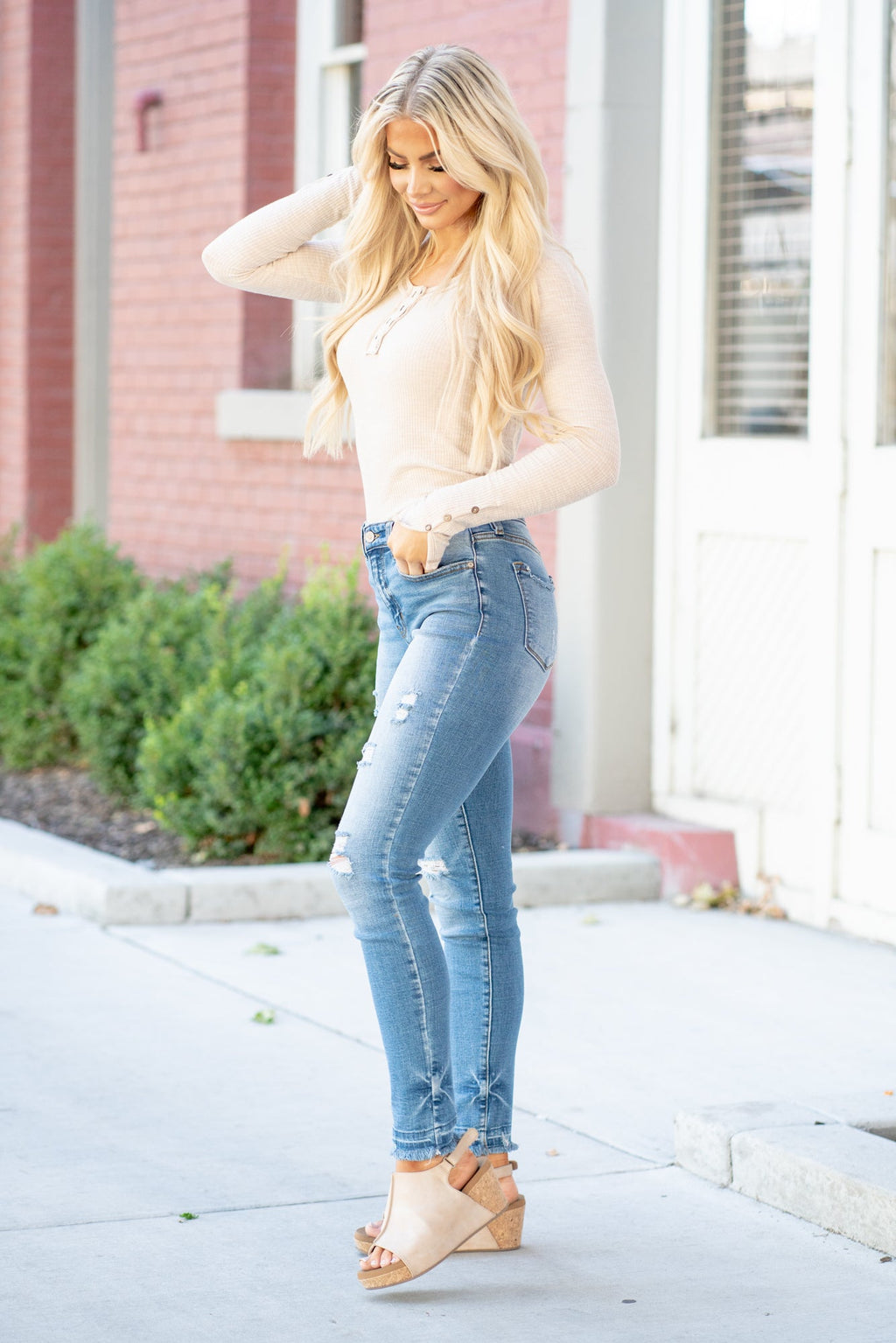 KanCan Jeans  These high-rise dark wash skinny jeans have a slightly distressed hem with a fitted skinny leg. Color: Medium Blue Cut: Skinny, 29.5" Inseam* Rise: High-Rise, 9.75" Front Rise* 98% COTTON 2% SPANDEX Stitching: Classic  Fly: Zipper Style #: KC8347M Contact us for any additional measurements or sizing.    *Measured on the smallest size, measurements may vary by size.   Cas is 5'7" and wears a size 25 in jeans, a small in tops, and 8 in shoes. She is wearing size 25 in these jeans. 