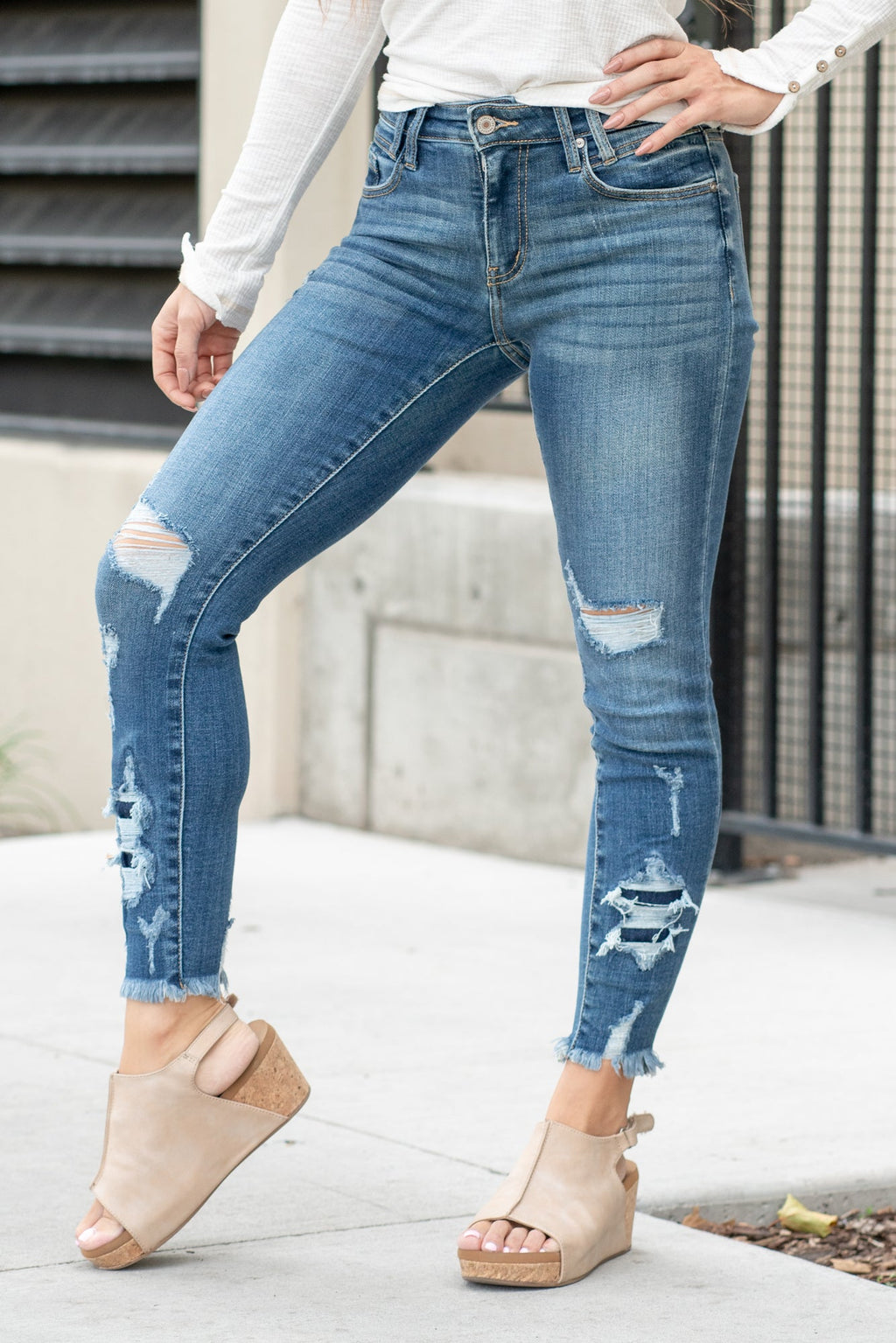 KanCan Jeans  Parkersburg are KanCans ankle skinny with a mid-rise fit. These have a fitted leg with a denim patch distress and a whiskered wash in medium blue.  Color: Medium Wash Ankle Skinny, 27" Inseam* Mid Rise, 9.25" Front Rise* Dyed Side Seam 93% COTTON , 6% POLYESTER , 1% SPANDEX Fly: Zipper Style #: KC2516M Contact us for any additional measurements or sizing.  
