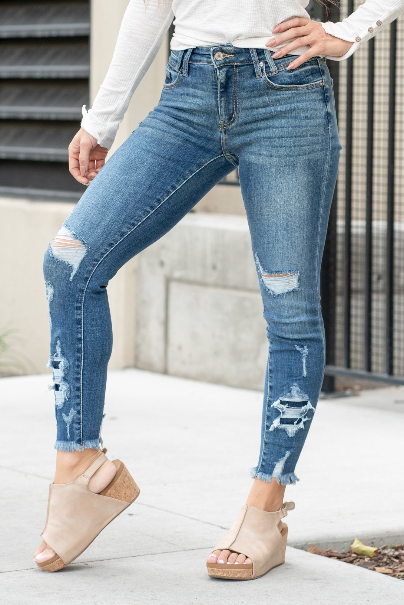 KanCan Jeans  Parkersburg are KanCans ankle skinny with a mid-rise fit. These have a fitted leg with a denim patch distress and a whiskered wash in medium blue.  Color: Medium Wash Ankle Skinny, 27" Inseam* Mid Rise, 9.25" Front Rise* Dyed Side Seam 93% COTTON , 6% POLYESTER , 1% SPANDEX Fly: Zipper Style #: KC2516M Contact us for any additional measurements or sizing.  