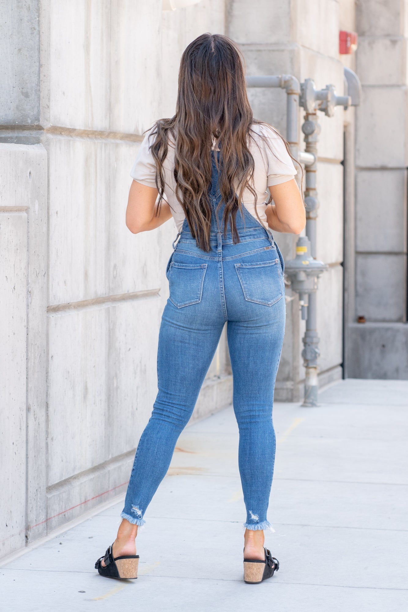 KanCan Jeans  98% Cotton 2% Spandex Medium Blue Cut: Skinny, 26.5" Inseam* Rise: High Rise, 10.25" Front Rise* Stitching: Classic Style #: KC7874M  Contact us for any additional measurements or sizing.  *Measured on the smallest size, measurements may vary by size.  Jacquelyn wears a size 25 in jeans, a small in tops, and 6.5 in shoes. She is wearing a size small in these overalls.