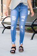 KanCan Jeans Collection: Core Collection Color: Medium Wash, 99% COTTON 1% SPANDEX Cut: Skinny, 29" Inseam* Rise: Mid-Rise, 8.5" Front Rise* Machine Wash Separately In Cold Water Stitching: Classic Fly: Zipper Style #: KC7103M Contact us for any additional measurements or sizing.  *Measured on the smallest size, measurements may vary by size.    Jacquelyn wears a size 25 in jeans, a small in tops, and 6.5 in shoes. She is wearing size 25 in these jeans.