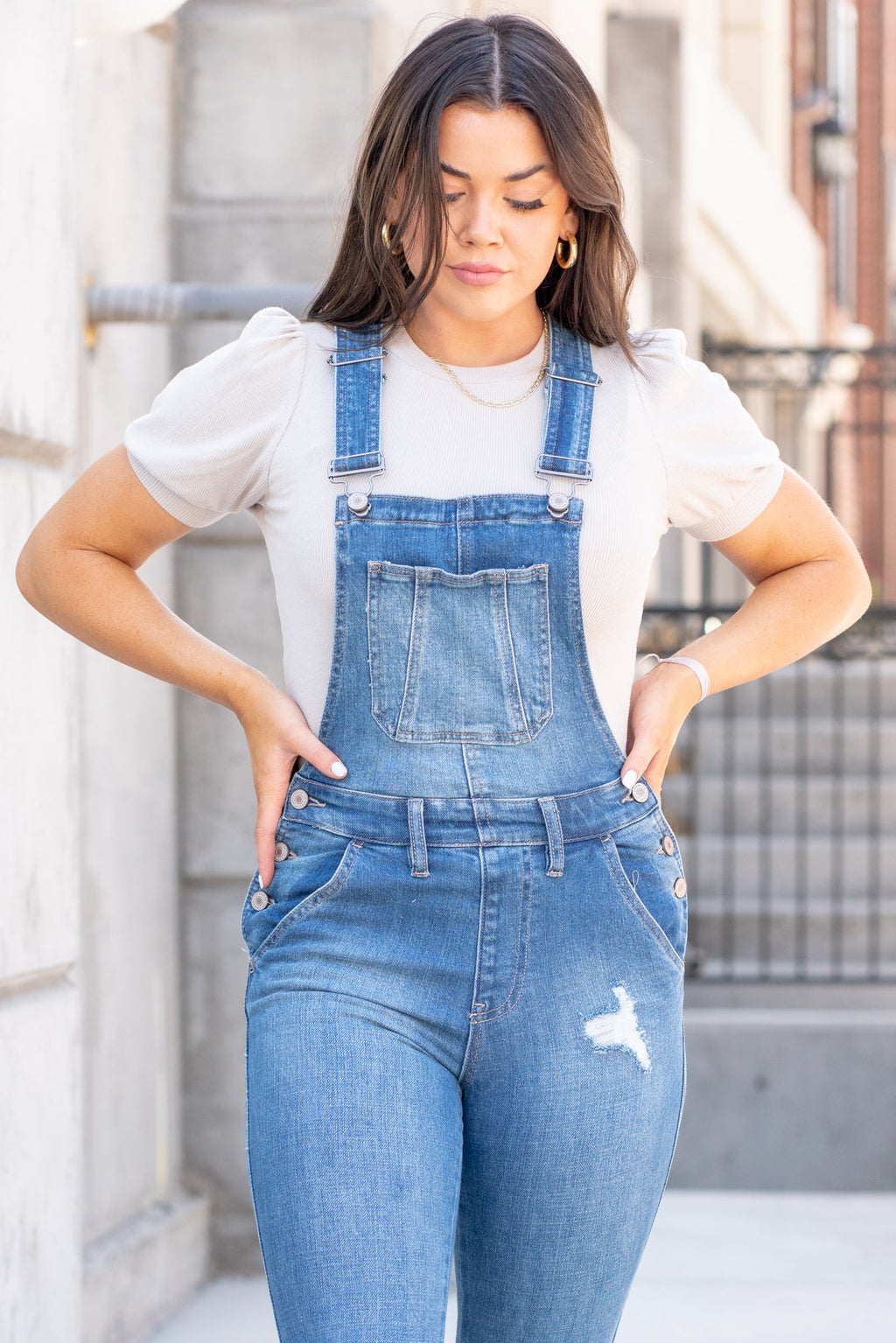 KanCan Jeans  98% Cotton 2% Spandex Medium Blue Cut: Skinny, 26.5" Inseam* Rise: High Rise, 10.25" Front Rise* Stitching: Classic Style #: KC7874M  Contact us for any additional measurements or sizing.  *Measured on the smallest size, measurements may vary by size.  Jacquelyn wears a size 25 in jeans, a small in tops, and 6.5 in shoes. She is wearing a size small in these overalls.