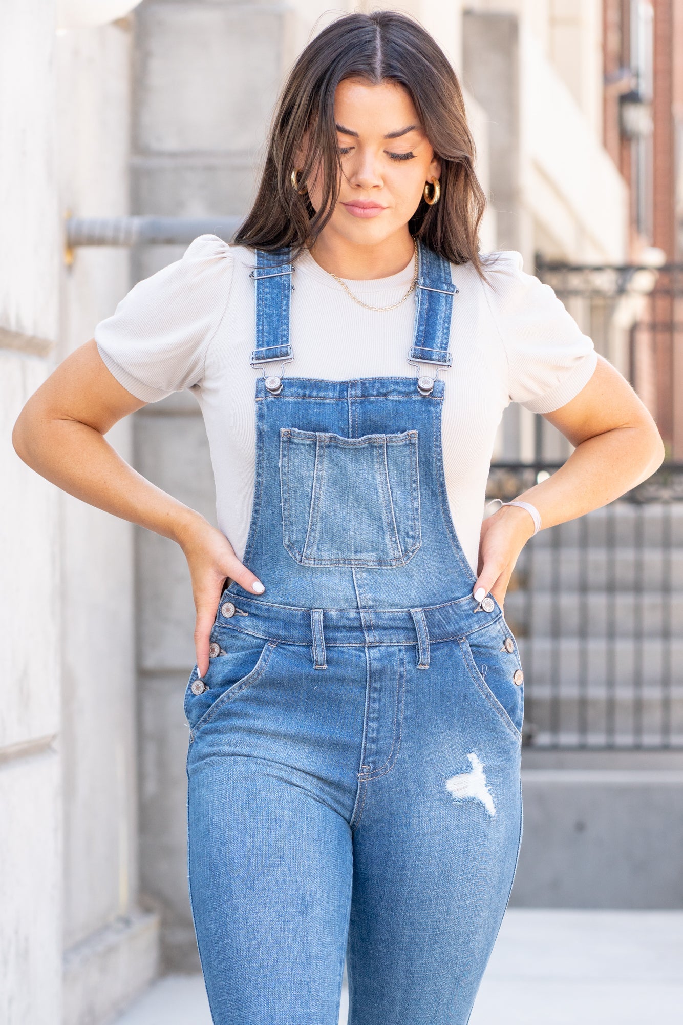 KanCan Jeans  98% Cotton 2% Spandex Medium Blue Cut: Skinny, 26.5" Inseam* Rise: High Rise, 10.25" Front Rise* Stitching: Classic Style #: KC7874M  Contact us for any additional measurements or sizing.  *Measured on the smallest size, measurements may vary by size.  Jacquelyn wears a size 25 in jeans, a small in tops, and 6.5 in shoes. She is wearing a size small in these overalls.