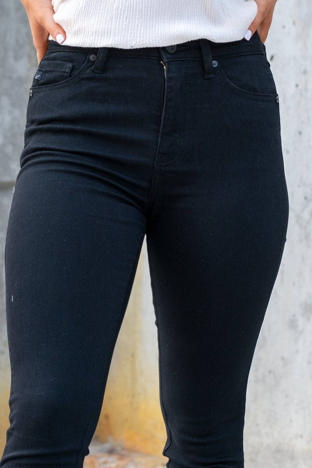 KanCan Jeans  These high rise medium wash skinny jeans have a spilt fray hem and fit above the ankles so you can show off you sandals this summer. Color: Black Cut: Skinny, 26.5" Inseam Rise: High-Rise, 10.5" Front Rise 72%COTTON, 25% POLYESTER, 3% SPANDEX Stitching: Classic Fly: Zipper Style #: KC8604BBK Contact us for any additional measurements or sizing.