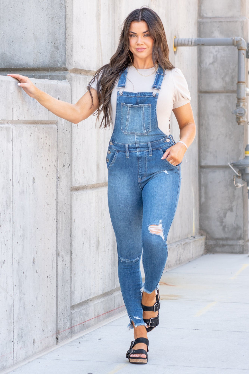 KanCan Jeans  98% Cotton 2% Spandex Medium Blue Cut: Skinny, 26.5" Inseam* Rise: High Rise, 10.25" Front Rise* Stitching: Classic Style #: KC7874M  Contact us for any additional measurements or sizing.  *Measured on the smallest size, measurements may vary by size.  Jacquelyn wears a size 25 in jeans, a small in tops, and 6.5 in shoes. She is wearing a size small in these overalls.