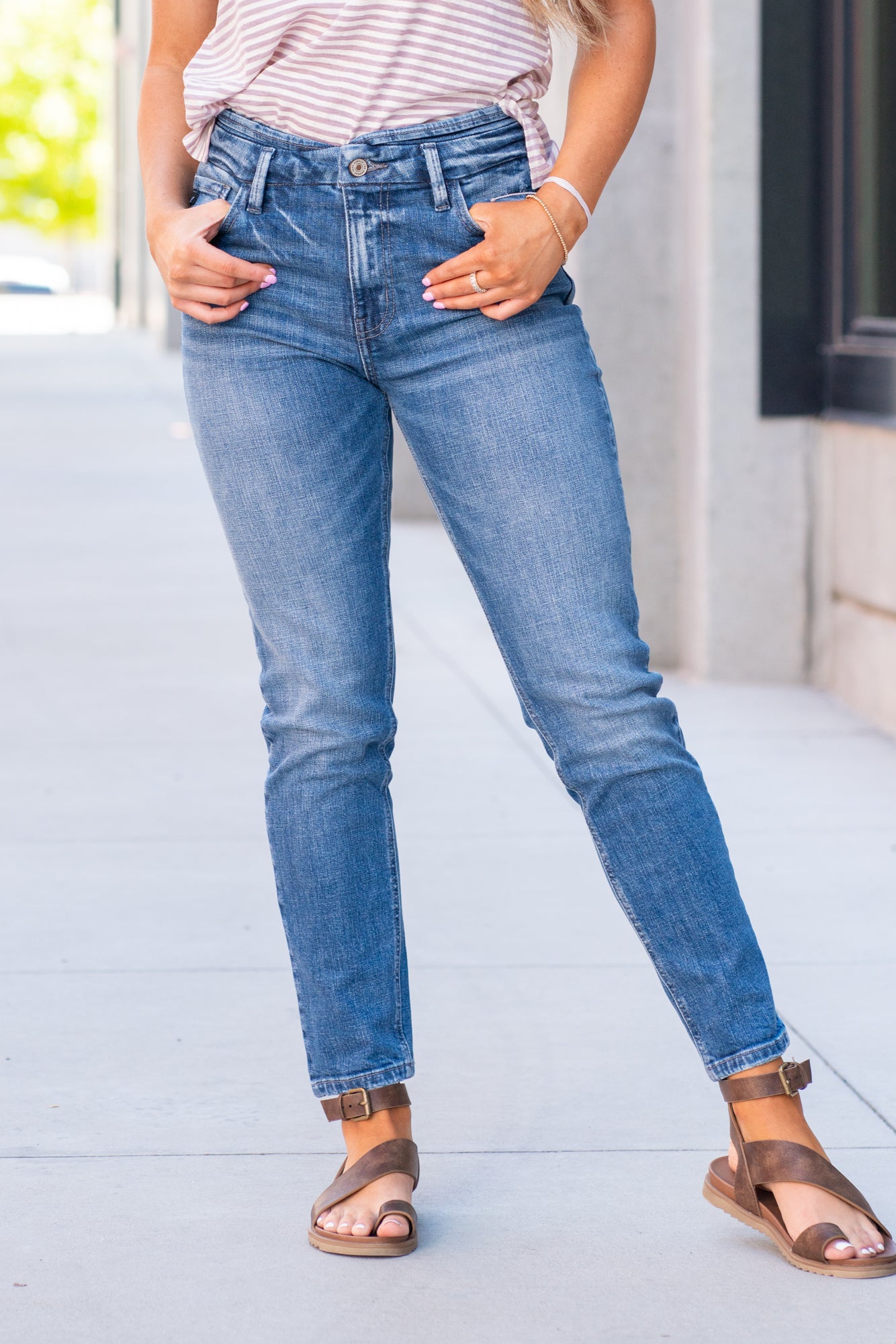 KanCan Jeans  With a high waist and mom fit, these will be your go-to jeans that will never go out of style. Color: Medium Blue  Cut: Mom Fit, 28" Inseam* Rise: High-Rise, 10.5" Front Rise* 98% Cotton 2% Spandex  Fly: Zipper Style #: KC8671M Contact us for any additional measurements or sizing.  *Measured on the smallest size, measurements may vary by size.